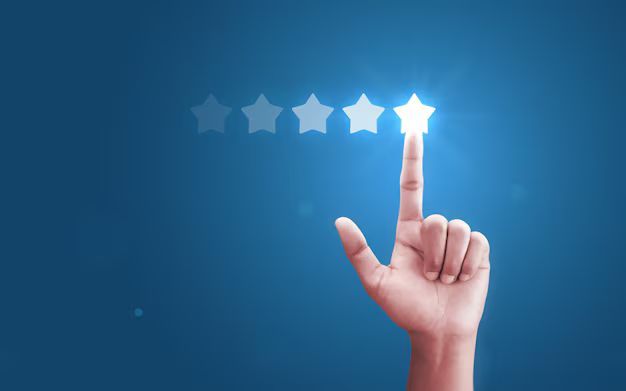 Hand pointing to a glowing star, part of a five-star rating system, on a blue background.