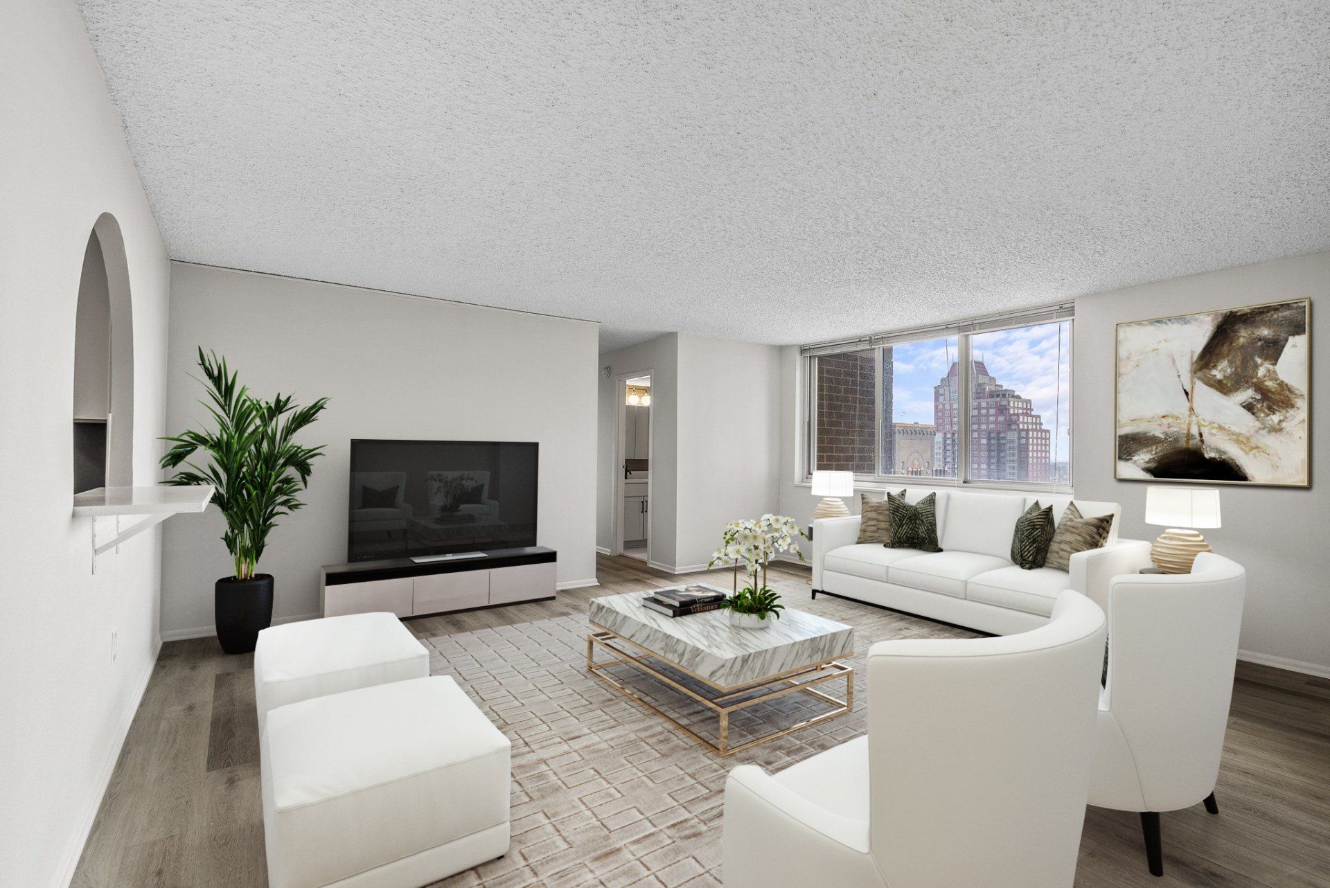 A living room with white furniture and a flat screen tv