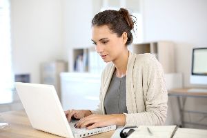 Woman Using Her Laptop — Ames, IA — Howell Investment Finance Woman Using Her Laptop — Ames, IA — Howell Investment Finance
