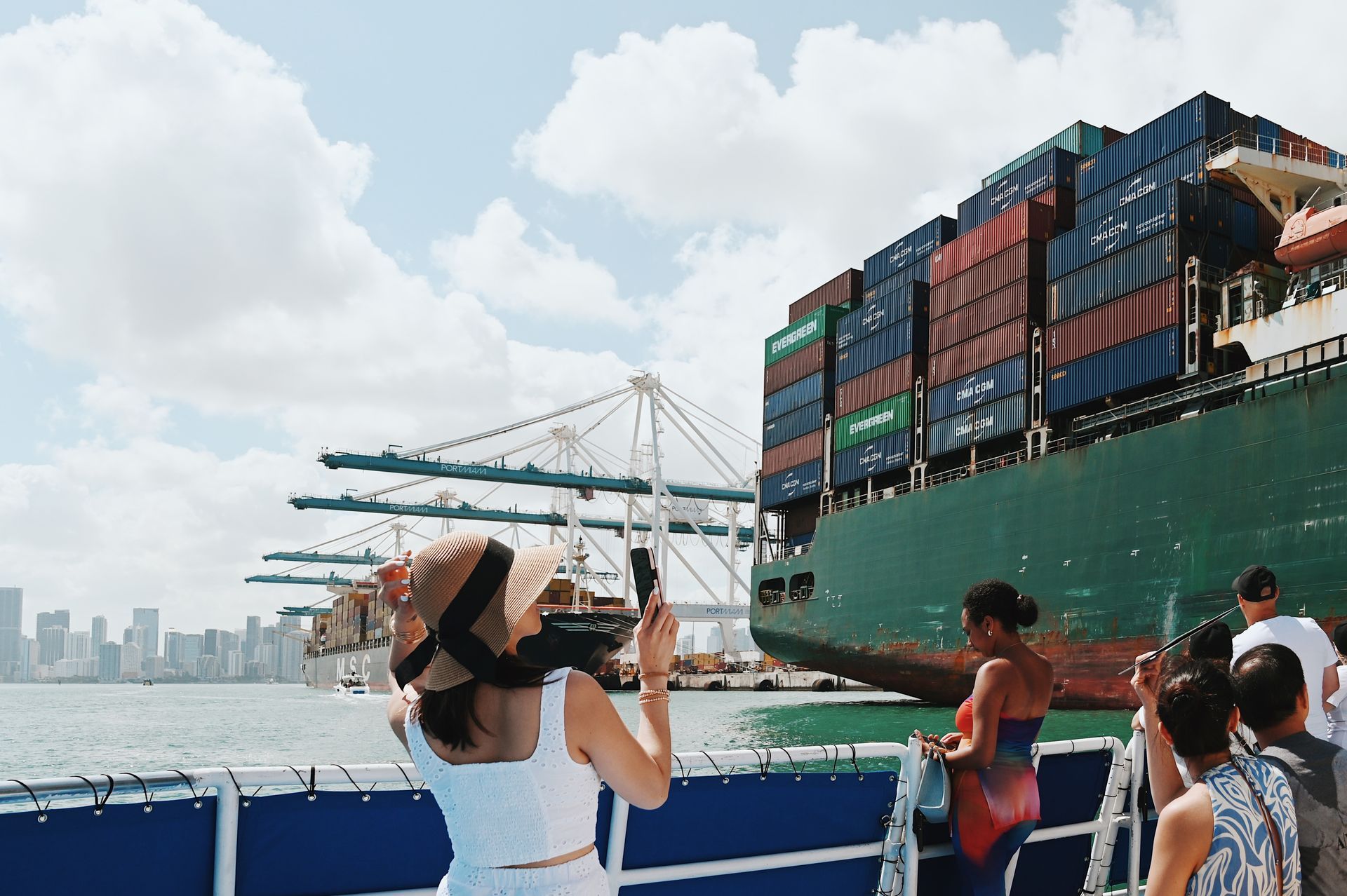 Passenger taking photos of Cargo ships seen on the Skyline Miami Cruises Route Map