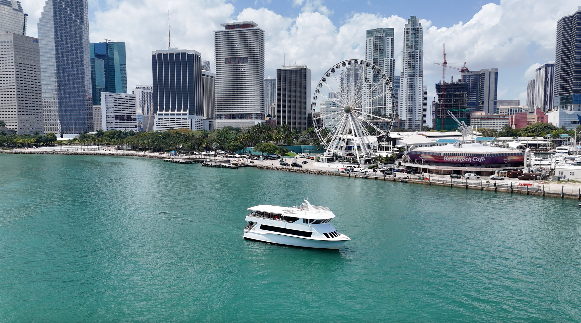 Miami Celebrity boat tour passing the Miami Skyline in Biscayne Bay