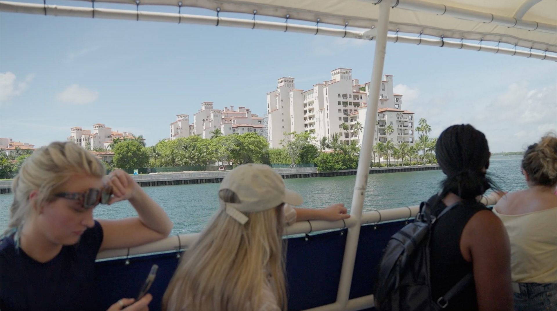 Guests taking selfies with Fisher Island in the background