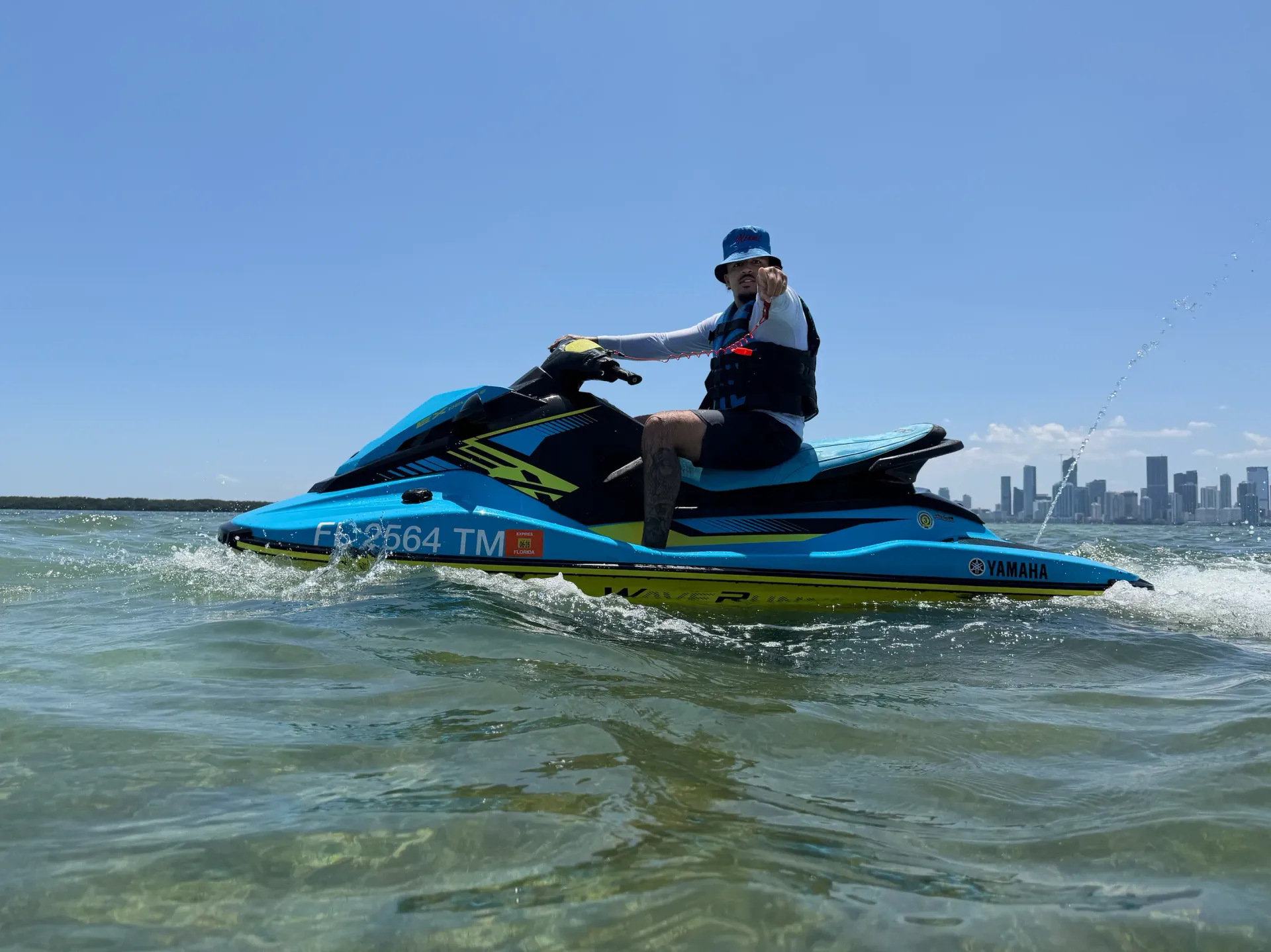 Rider enjoying Bayside Jet Ski Rentals on Biscayne Bay with the Downtown Miami skyline in the background