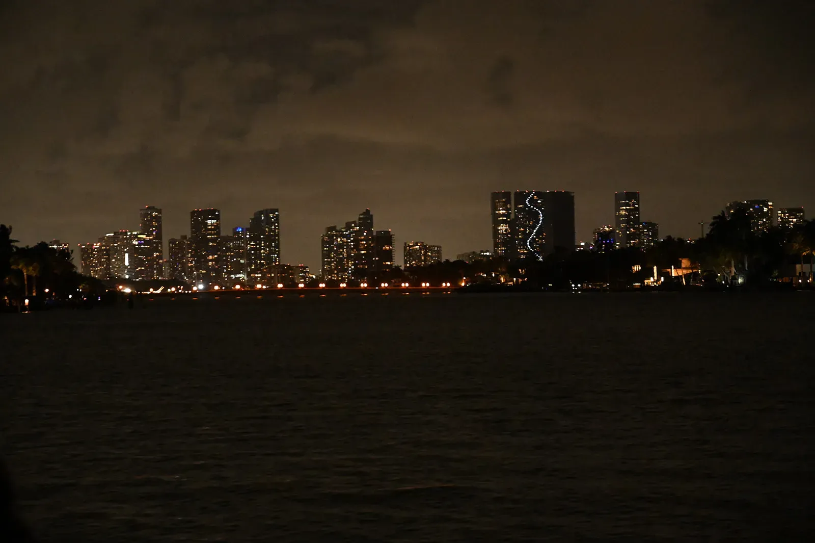 Miami skyline lights reflecting across Biscayne Bay during one of the Miami Night Cruises