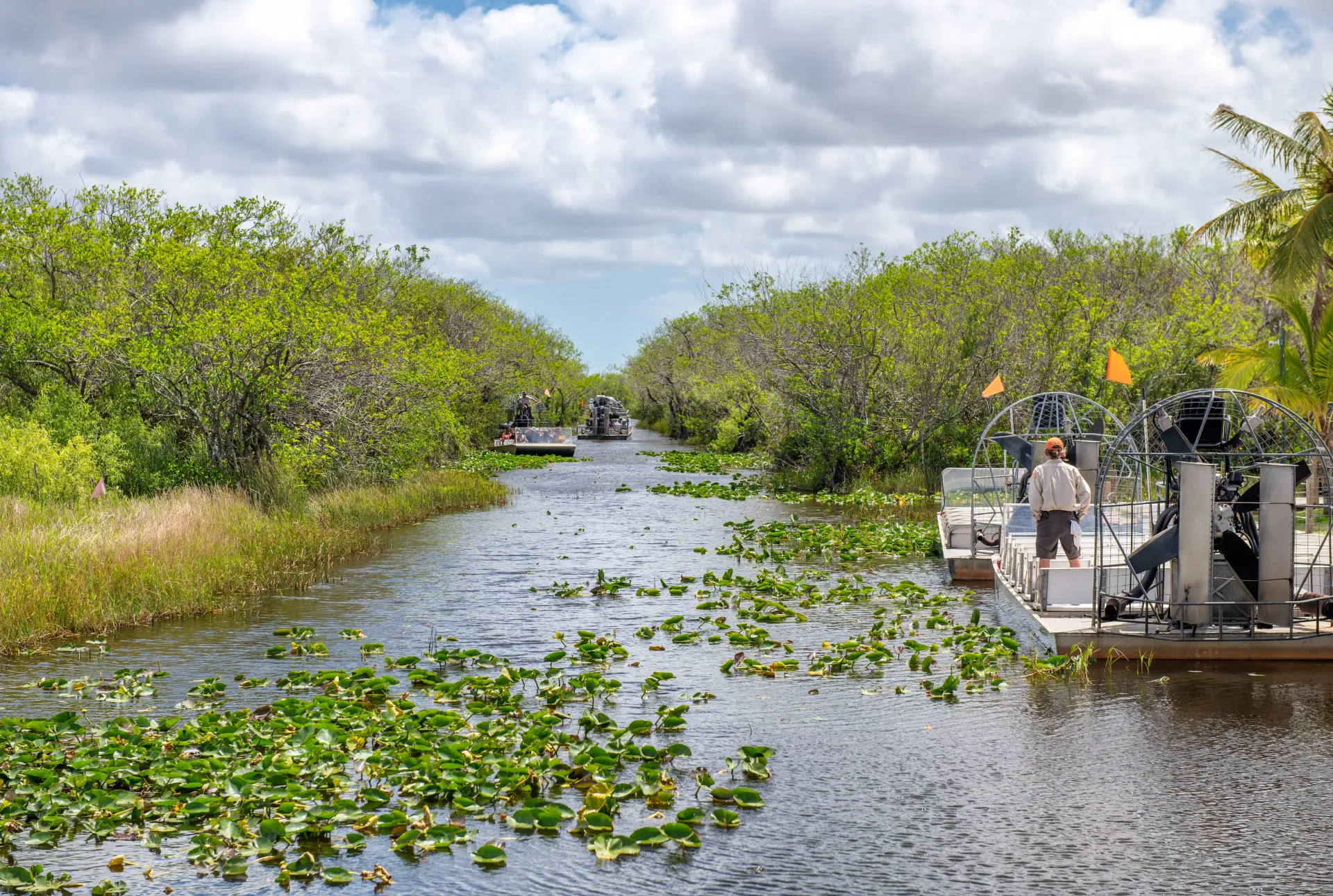 Airboats traveling through the Florida Everglades during a guided Everglades tour from Miami.