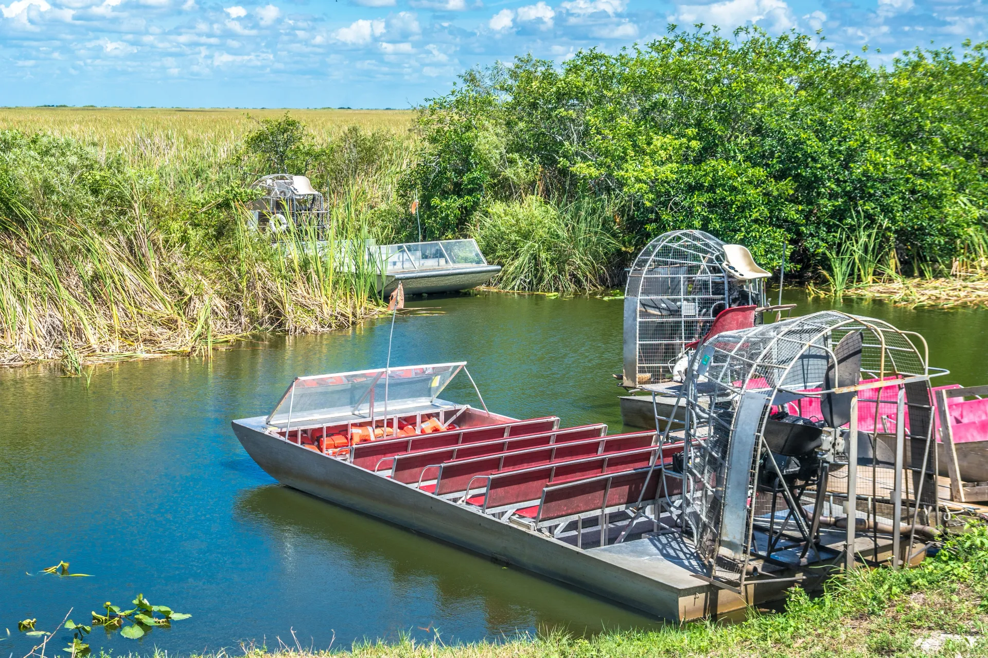 Traditional Everglades airboats waiting for guests before a guided airboat tour through the Florida Everglades.