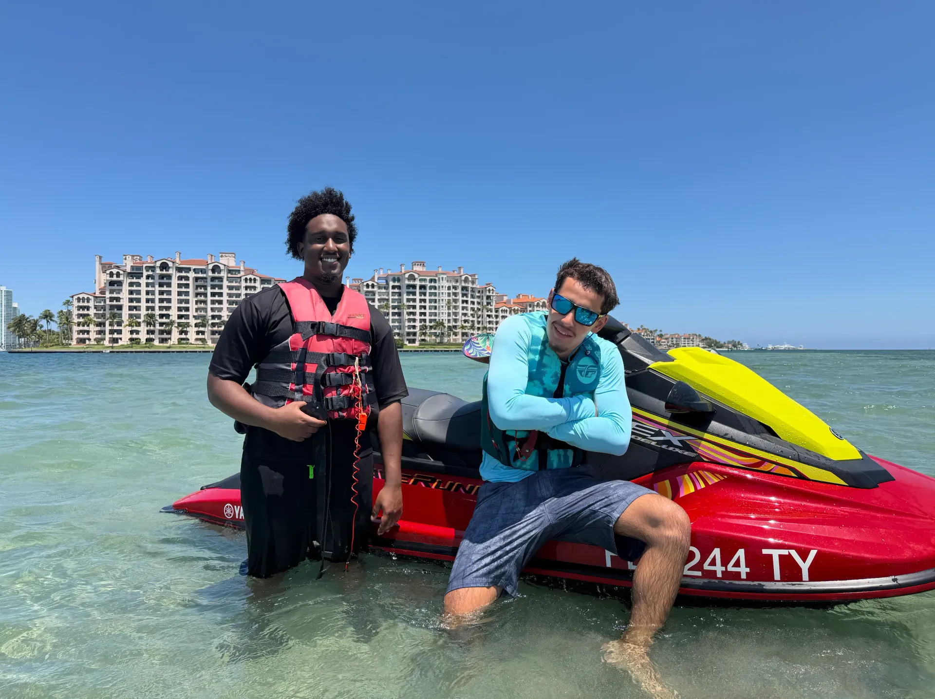 Guests enjoying family-friendly Miami Jet Ski Rentals near Fisher Island in shallow tropical waters