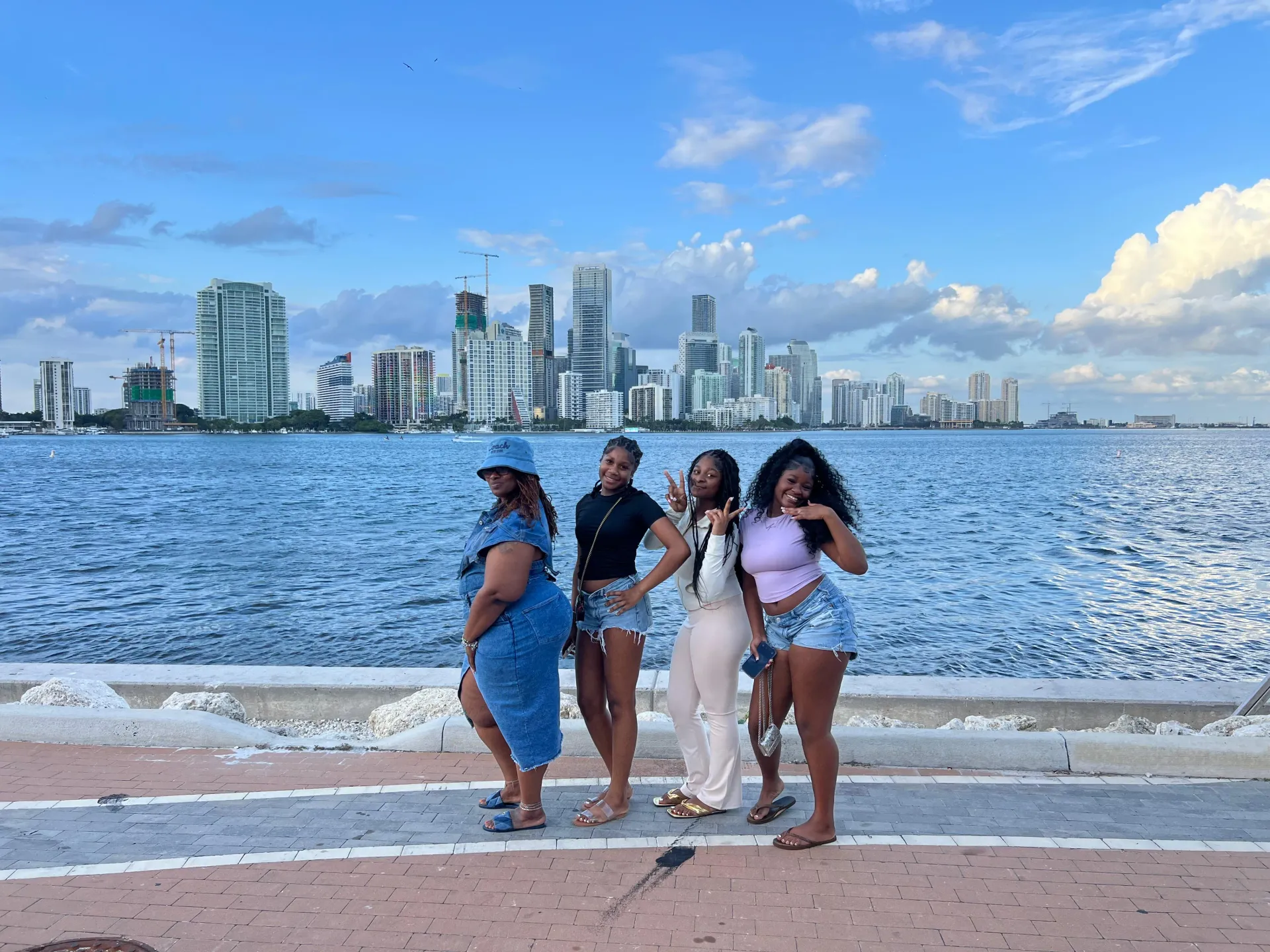 Guests posing at a Downtown Miami waterfront photo stop during one of our Miami tours.