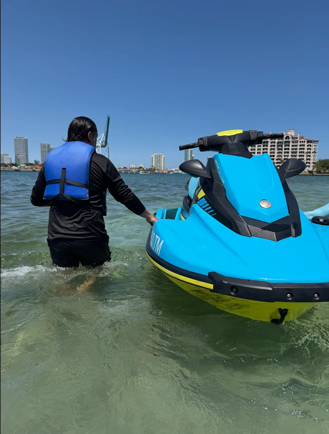 Guest preparing for a guided Bayside Miami jet ski adventure in shallow clear water