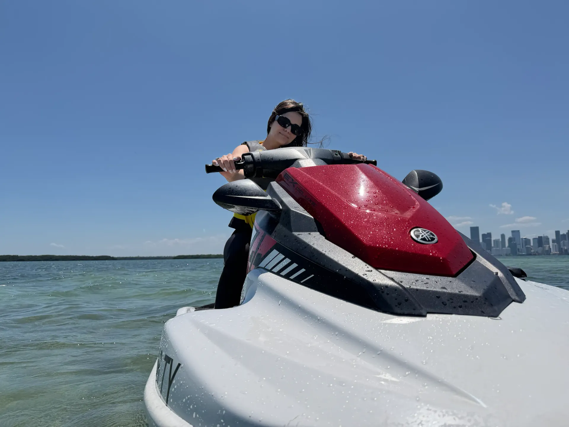 Guest enjoying jet ski rentals Miami with the Downtown Miami skyline in the background