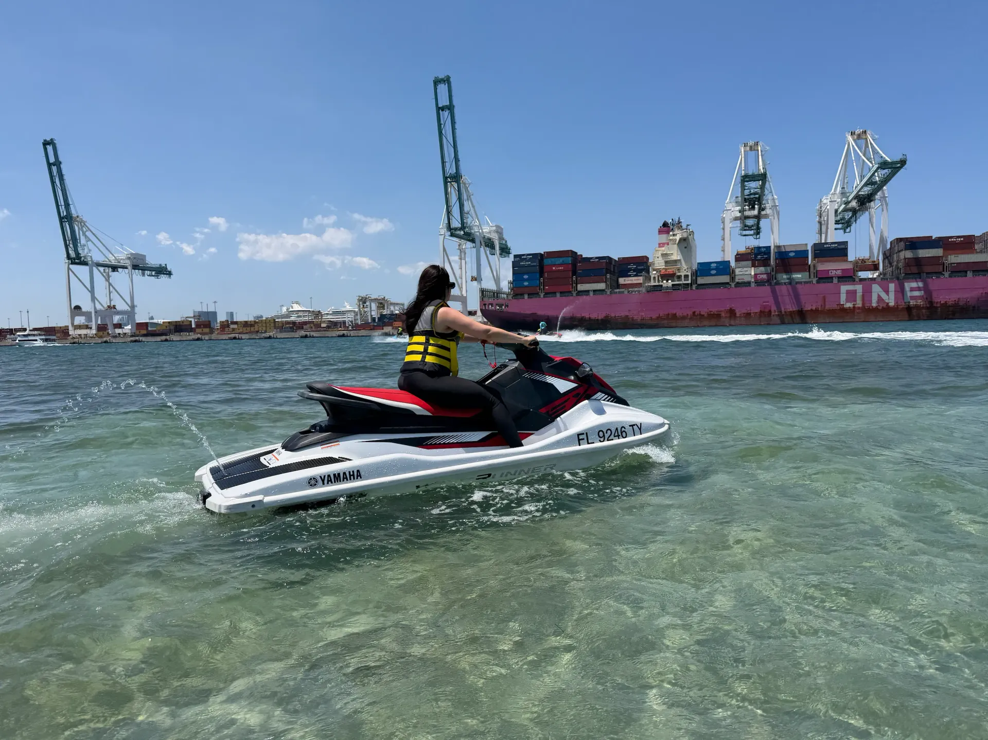 Guest enjoying jet ski rentals Miami near the Port of Miami cargo ships and Downtown waterfront