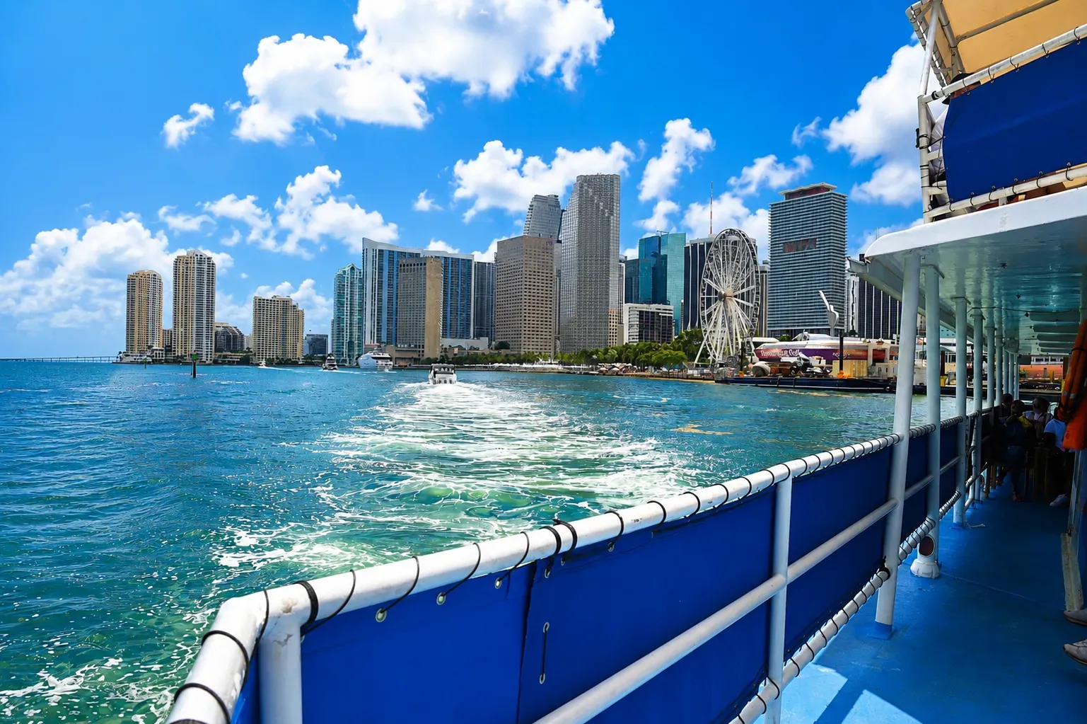 View of the Downtown Miami skyline from a sightseeing boat cruising across Biscayne Bay during the afternoon.