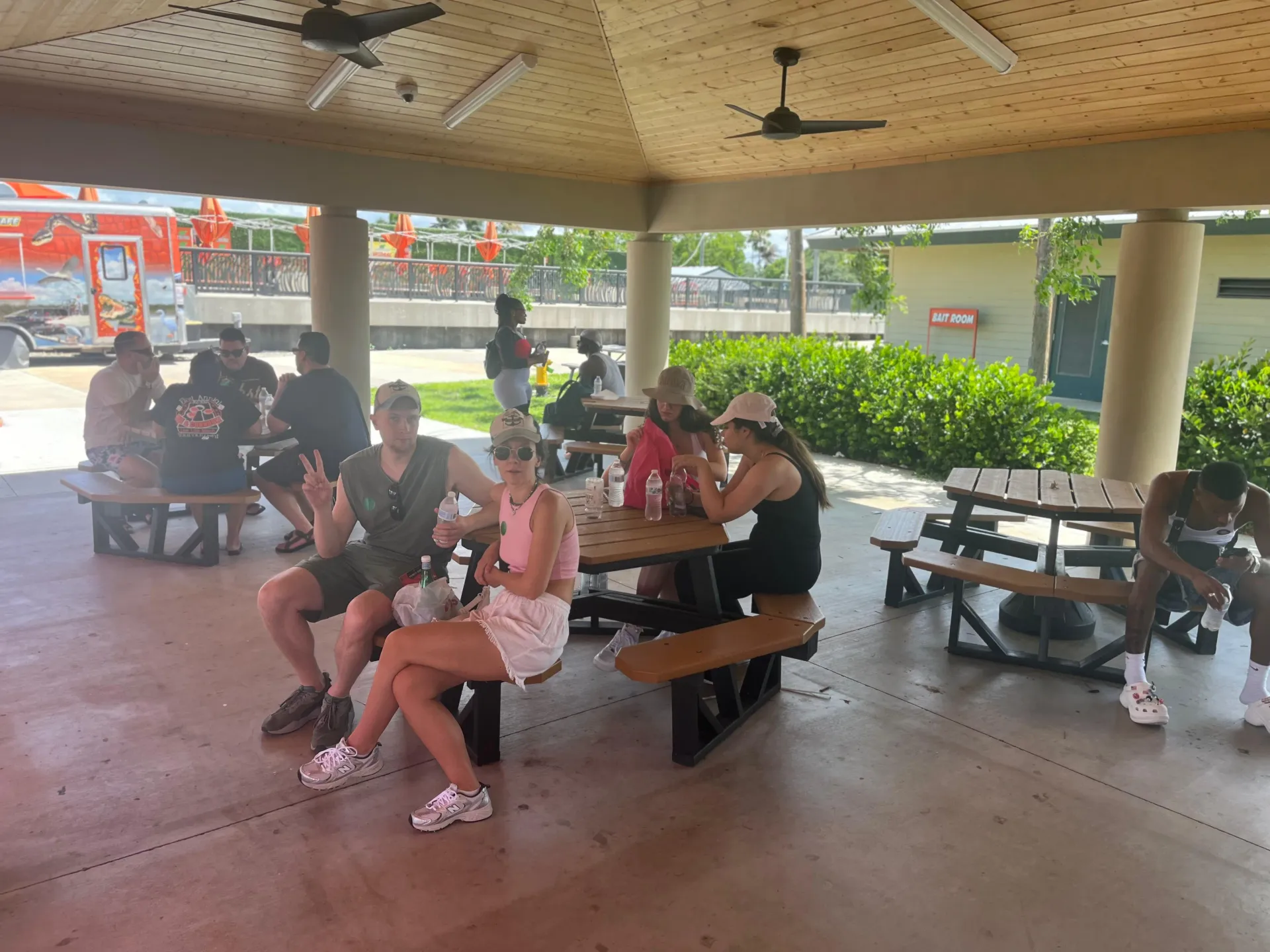 Guests relaxing in the shaded picnic area during their Miami Everglades Tour before and after the airboat ride.