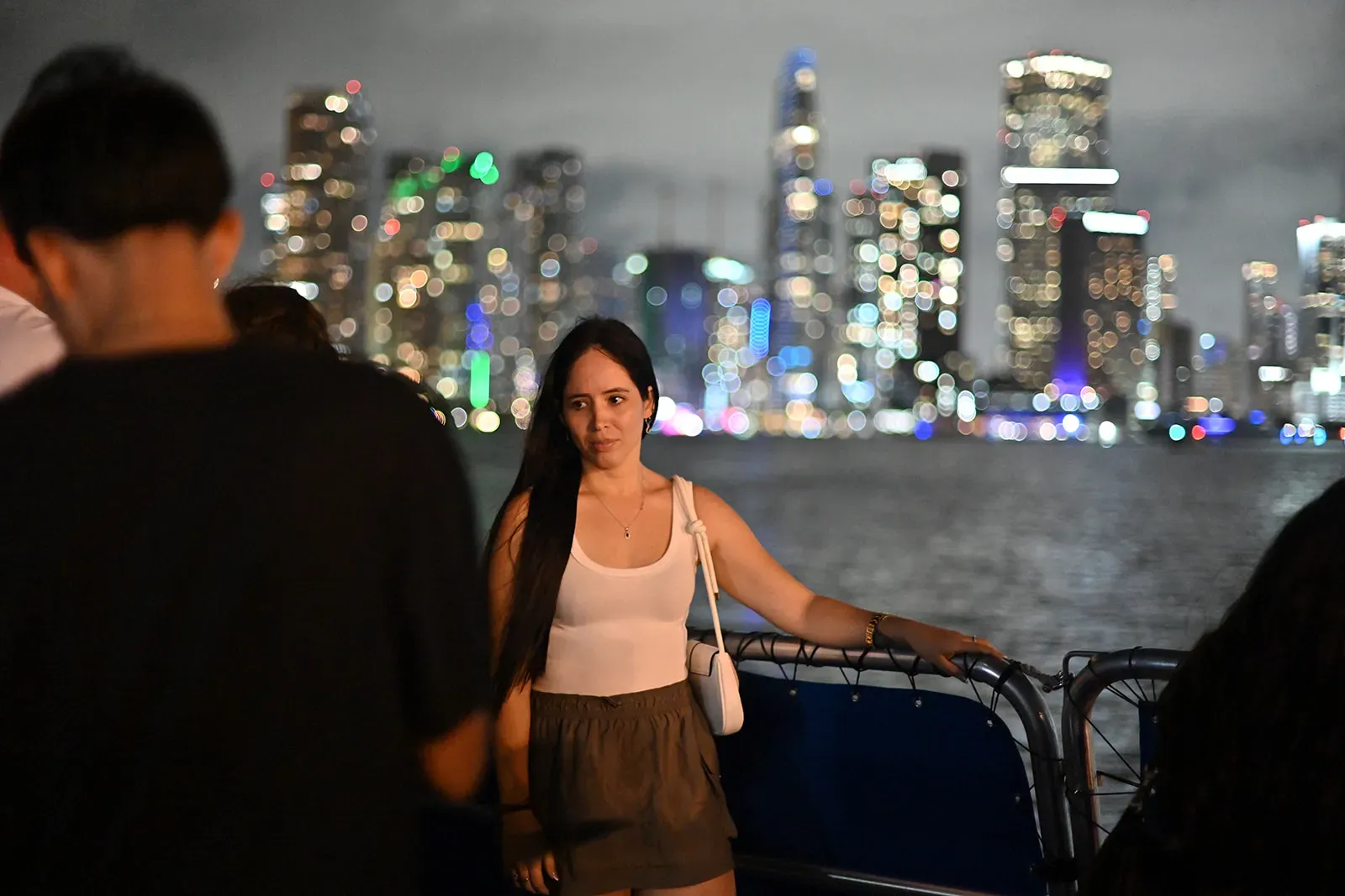 Guests enjoying waterfront nightlife views during a Miami sightseeing boat experience after dark