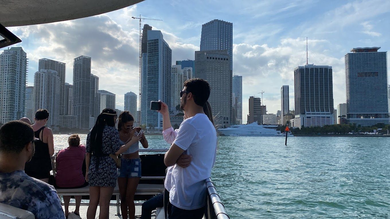 Guests enjoying a Miami sightseeing millionaires cruise while viewing the city from the water.