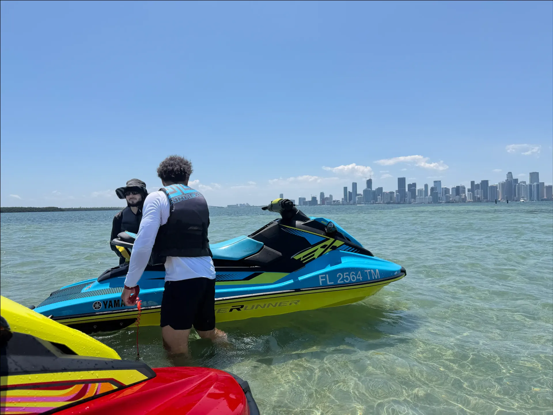 Guests preparing for a Miami Skyline Jet Ski Rental experience with Downtown Miami views in the background