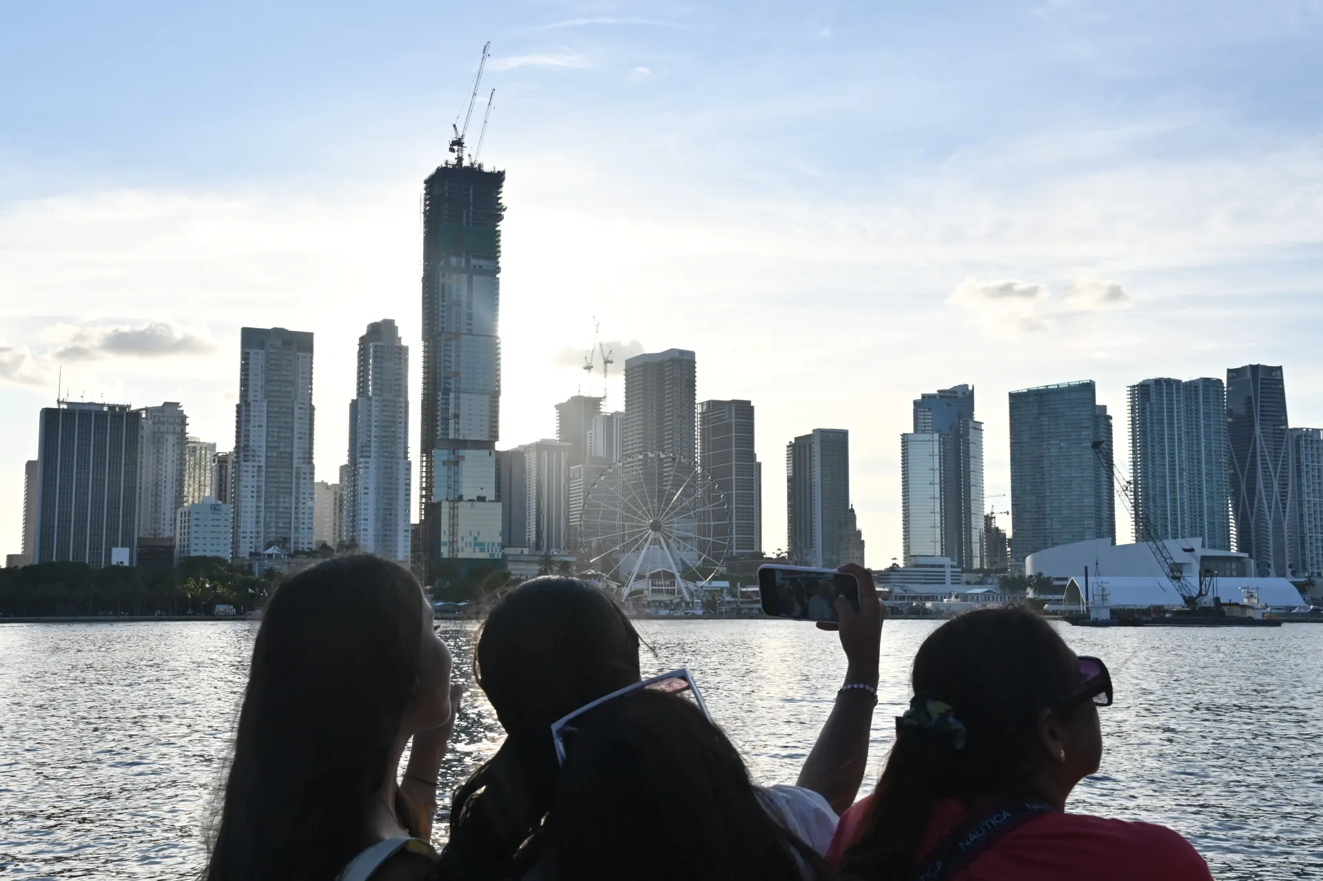 Passengers viewing the Miami skyline from a sightseeing boat.