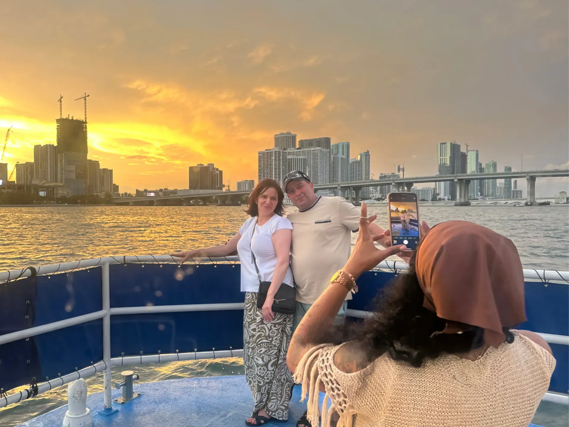 Guests taking photos during a Miami Sunset Cruise departing from 401 Biscayne Boulevard, Miami Florida 33132