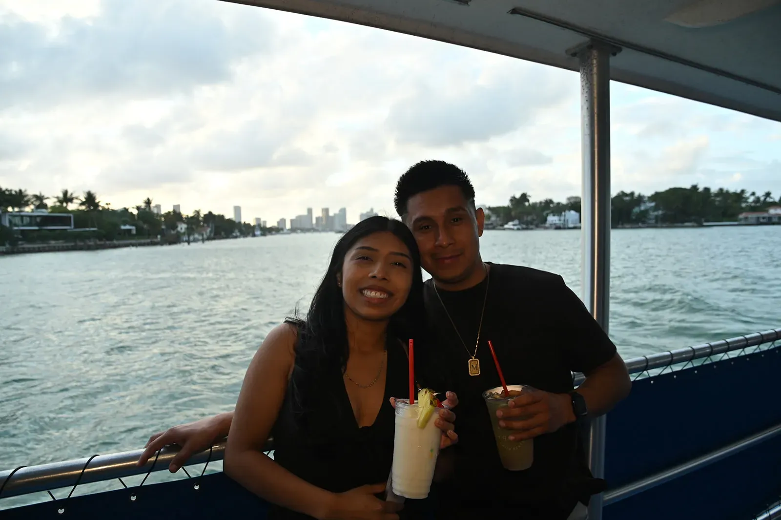 Couple enjoying drinks during Miami Sunset Cruises with skyline views and waterfront scenery in Downtown Miami