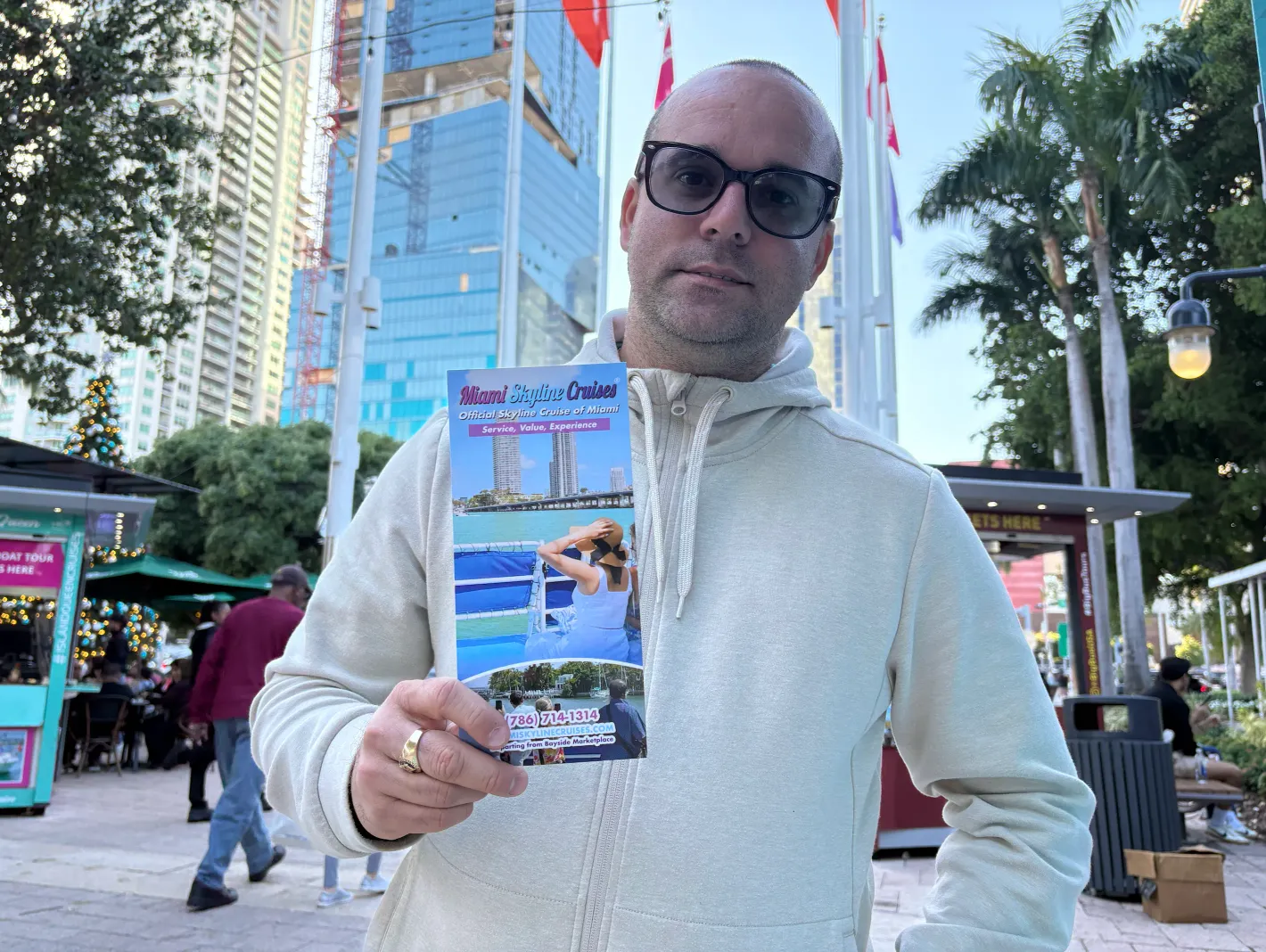 Guest reviewing a Miami tour guide brochure before visiting local attractions.