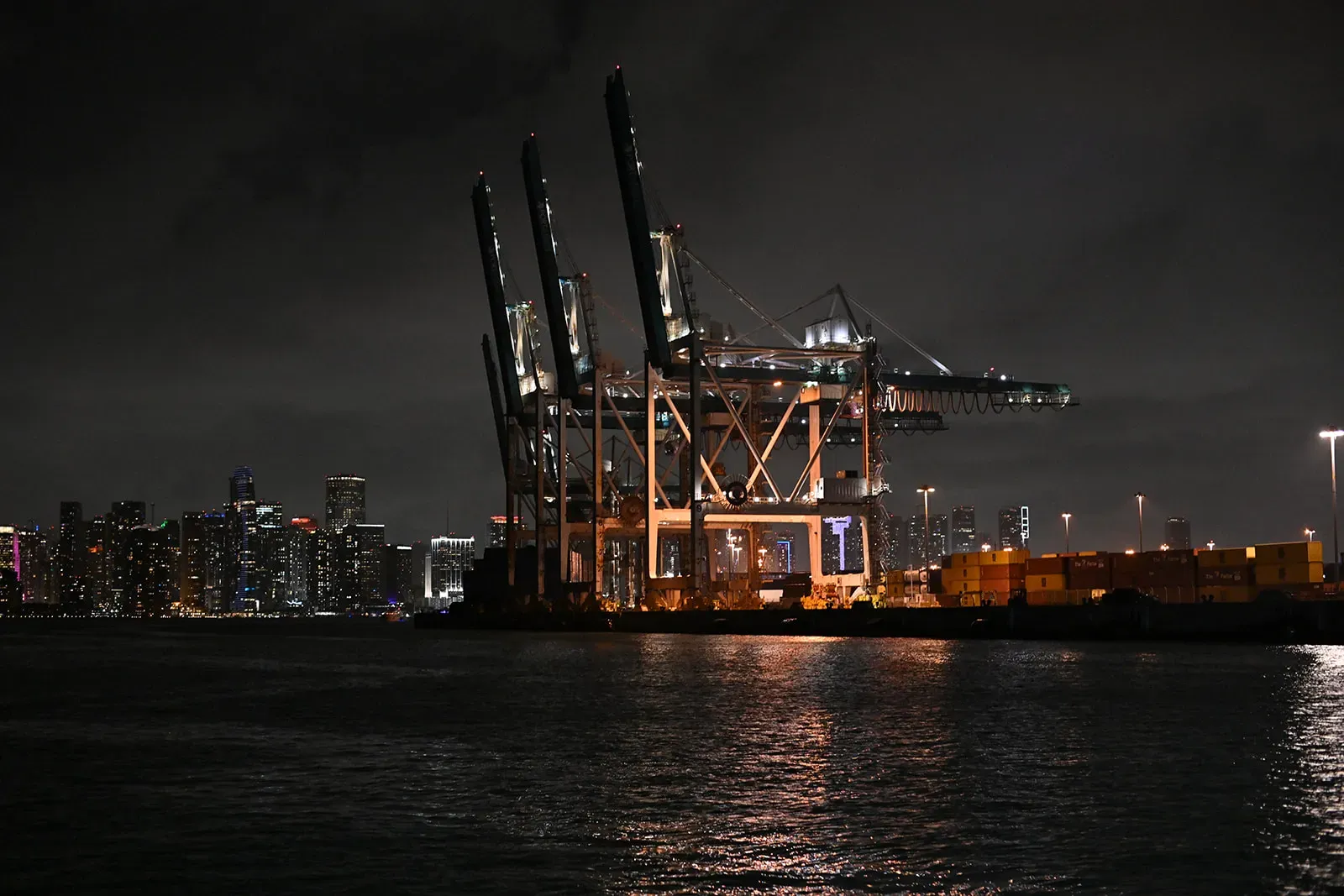 PortMiami cargo cranes and nighttime waterfront views with Downtown Miami in the background