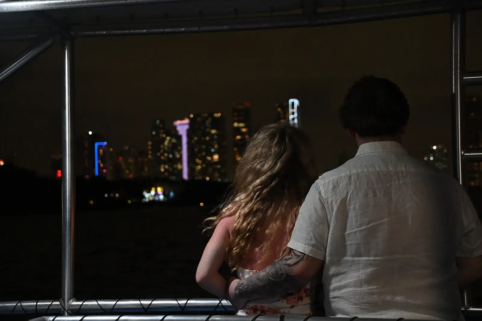 Couple enjoying the Miami skyline during a romantic nighttime cruise on Biscayne Bay
