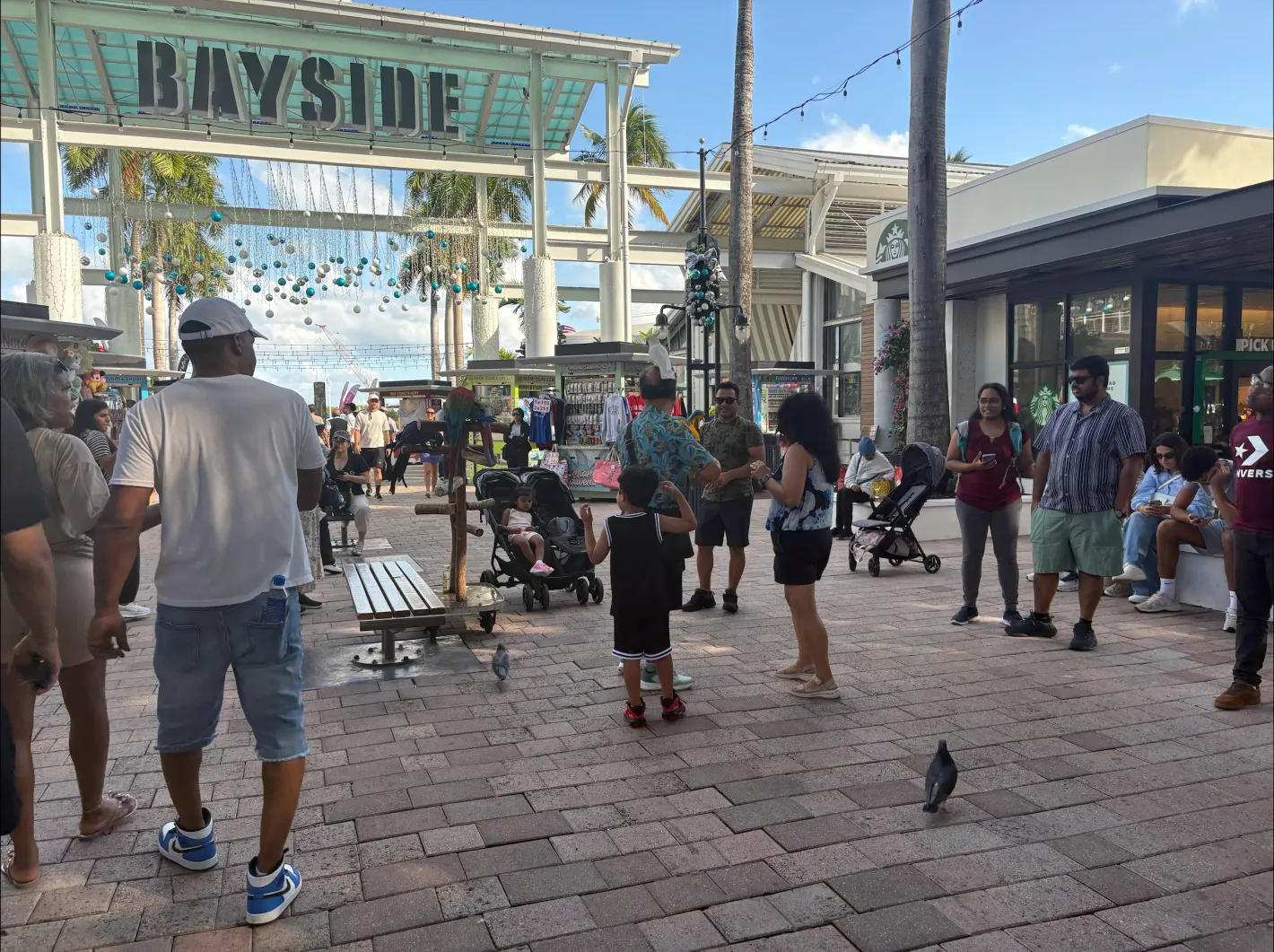 Visitors exploring Bayside Marketplace before joining a Miami tour.