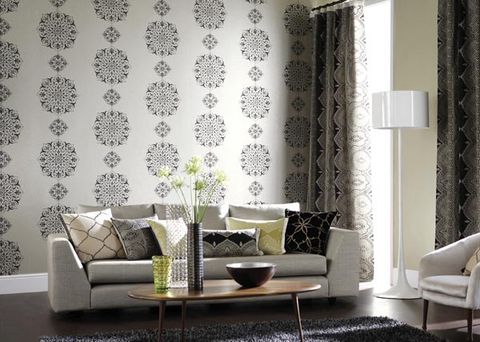 living room with sofa and ornaments in front of large window with curtains