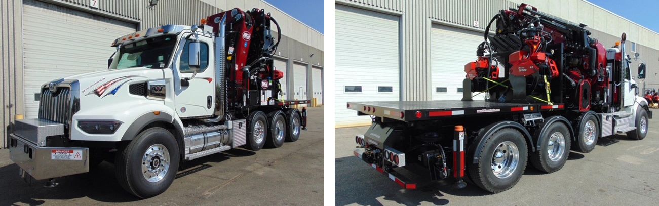 White truck with red crane. Parked on a sunny day. Large wheels, flatbed.