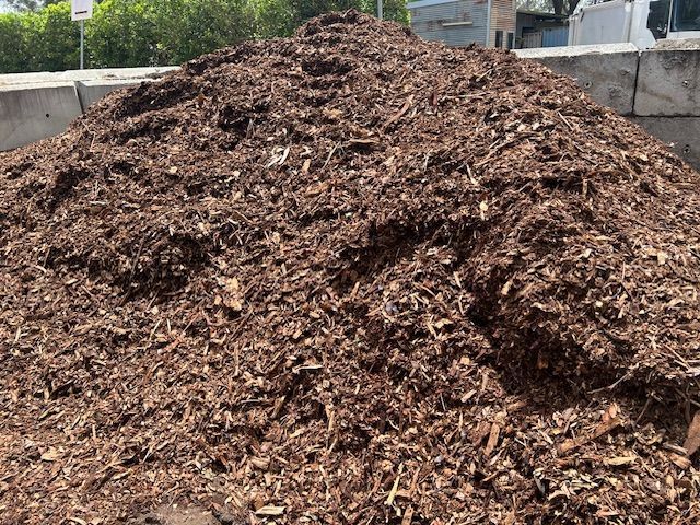 Pile of Dark Brown Mulch — Gladstone Garden & Landscaping Supplies In Burua, QLD