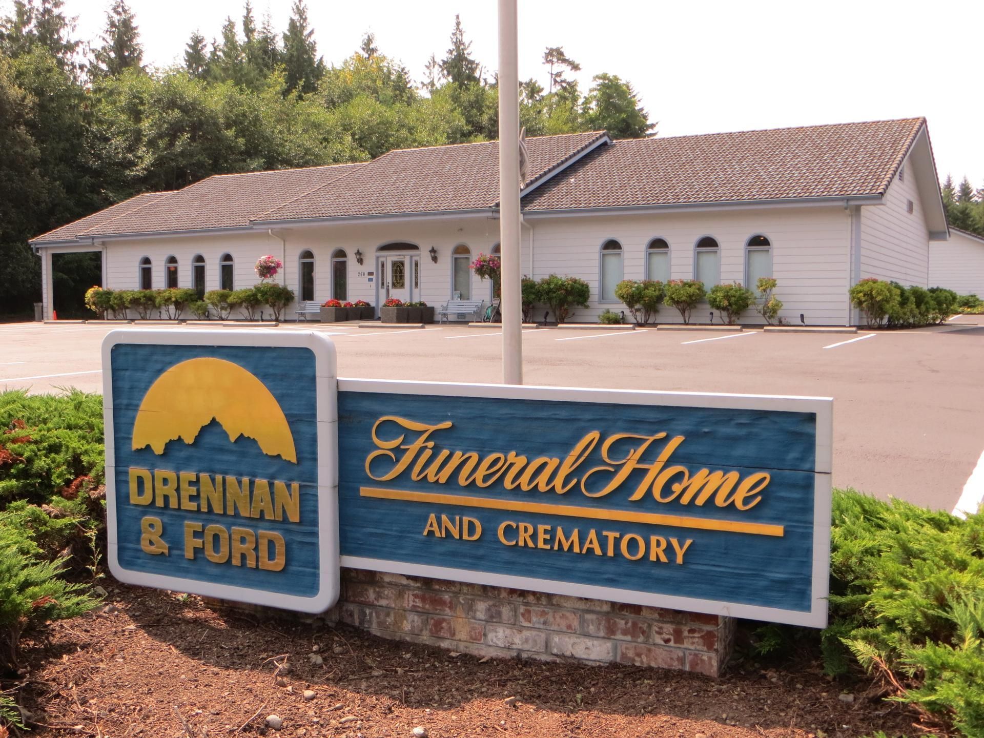 Brennan & Ford Funeral Home and Crematory sign in front of a white building