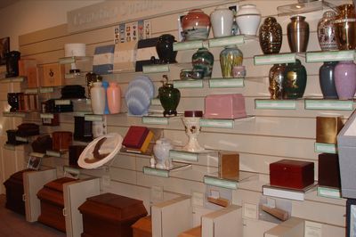 Shelves of assorted pottery, vases, and decorative dishes displayed in a shop or gallery.