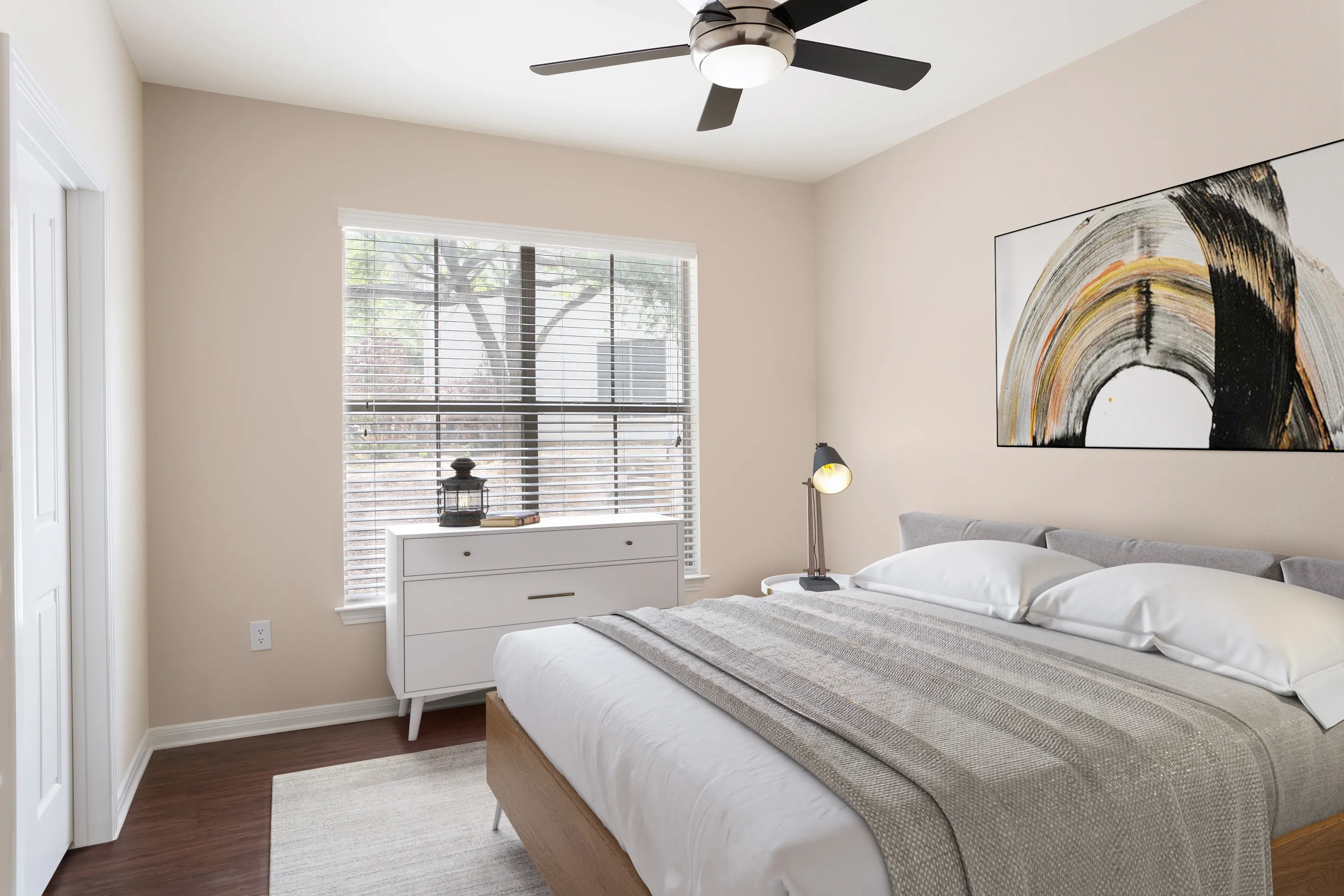 Bright bedroom with a bed, dresser, lamp, ceiling fan, and window with blinds