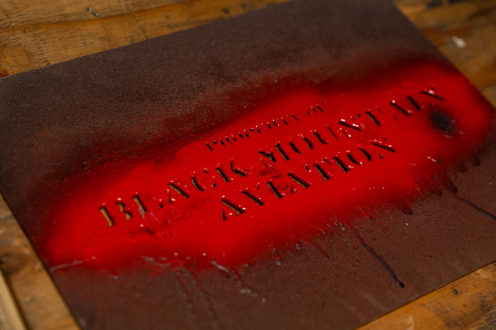 `` black mountain aviation '' written on it is sitting on a wooden table.