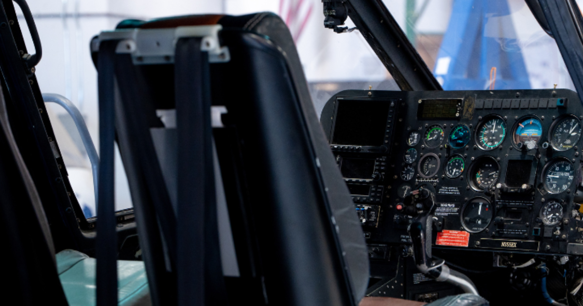 Helicopter cockpit with legacy analog avionics before Garmin upgrade at Black Mountain Aviation in B