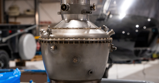 Certified technician inspecting Safran Arriel 1D1 engine module on Airbus H125 helicopter