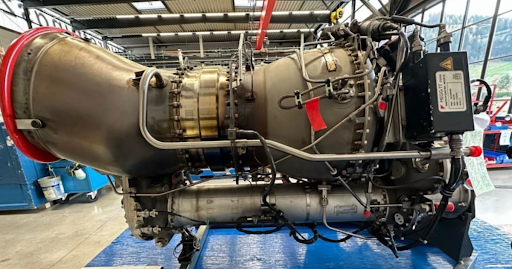Safran Arriel helicopter engine module displayed in a maintenance facility, showing turbine components, reduction gearbox assemblies, and modular design used for certified engine servicing.
