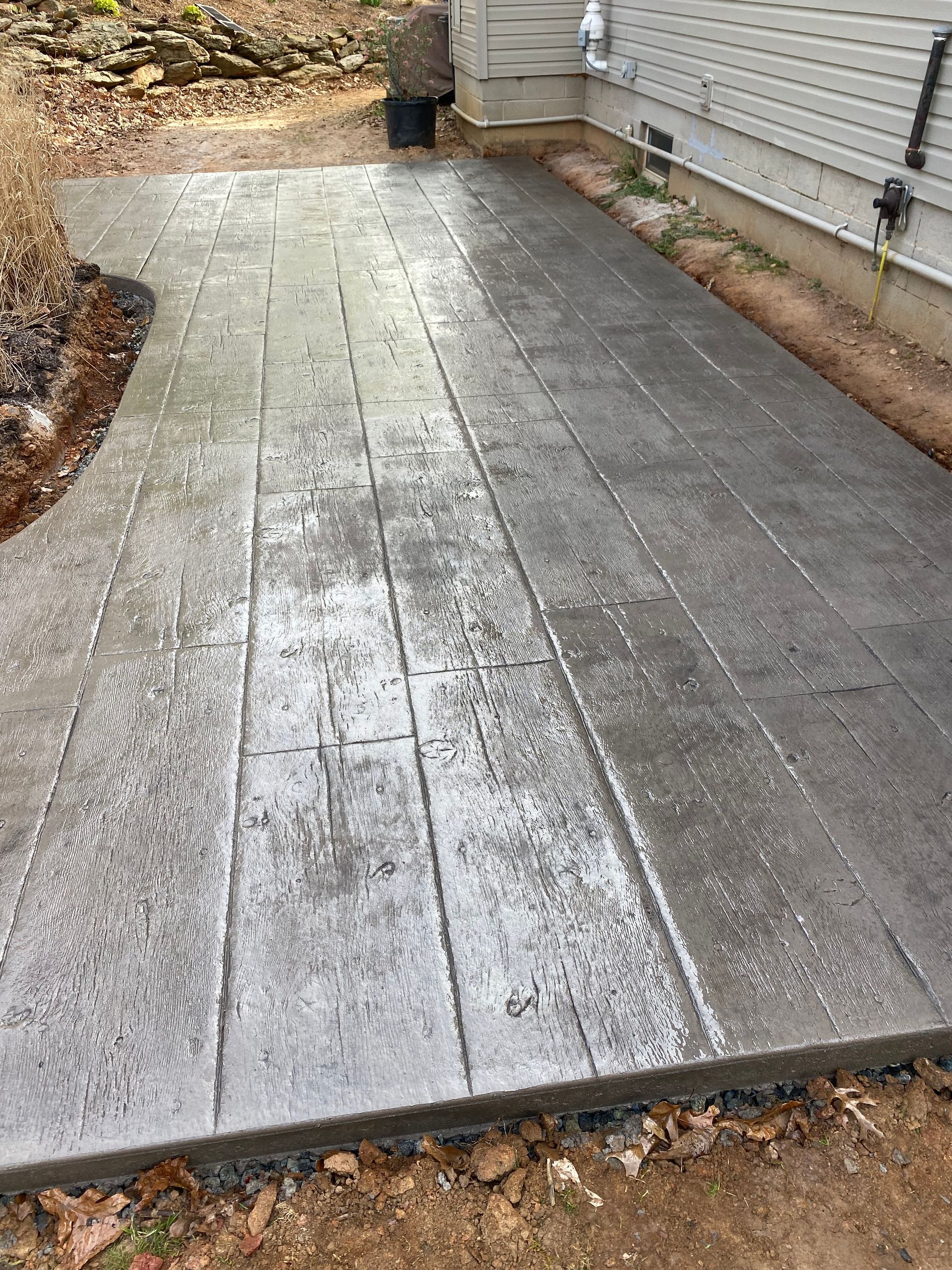 grey wood plank stamped concrete patio