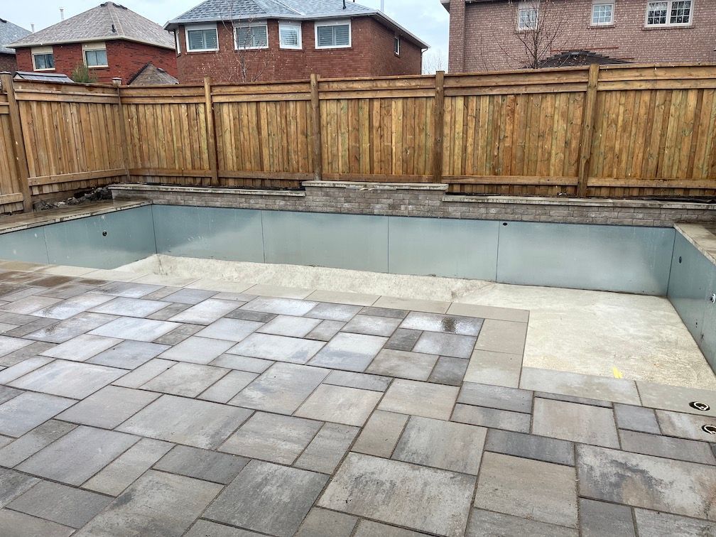 A large swimming pool with a wooden fence around it