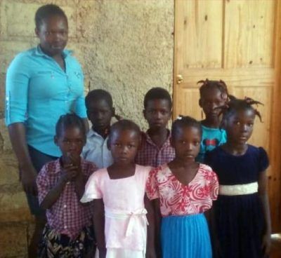 A group of children posing for a picture with their teacher