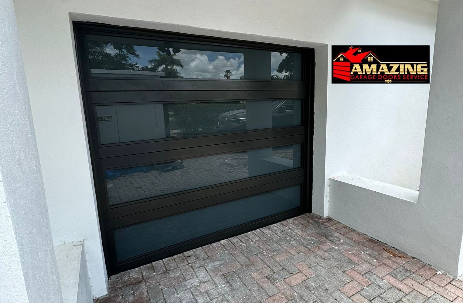A black garage door with a sign that says amazing on it.
