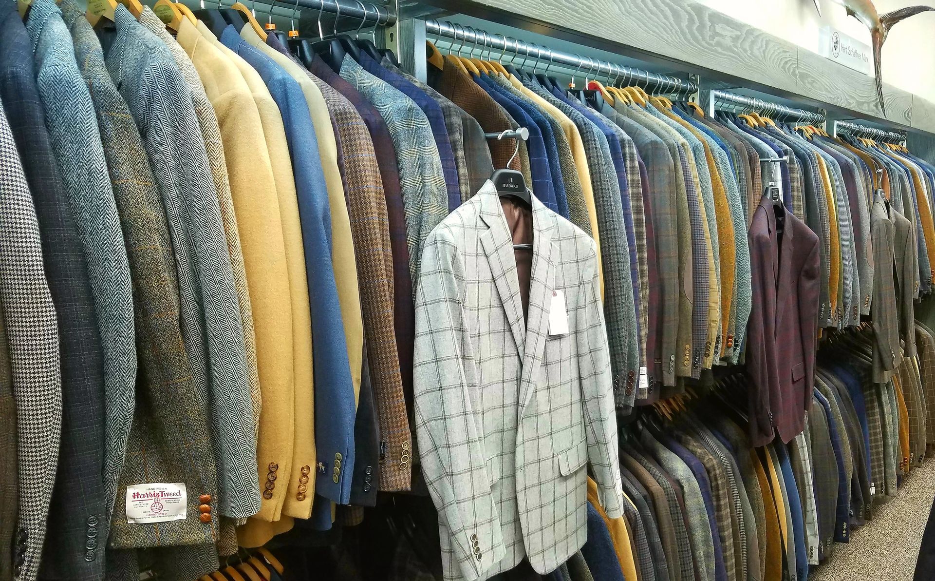 Men's sportcoats and jackets displayed on clothing racks