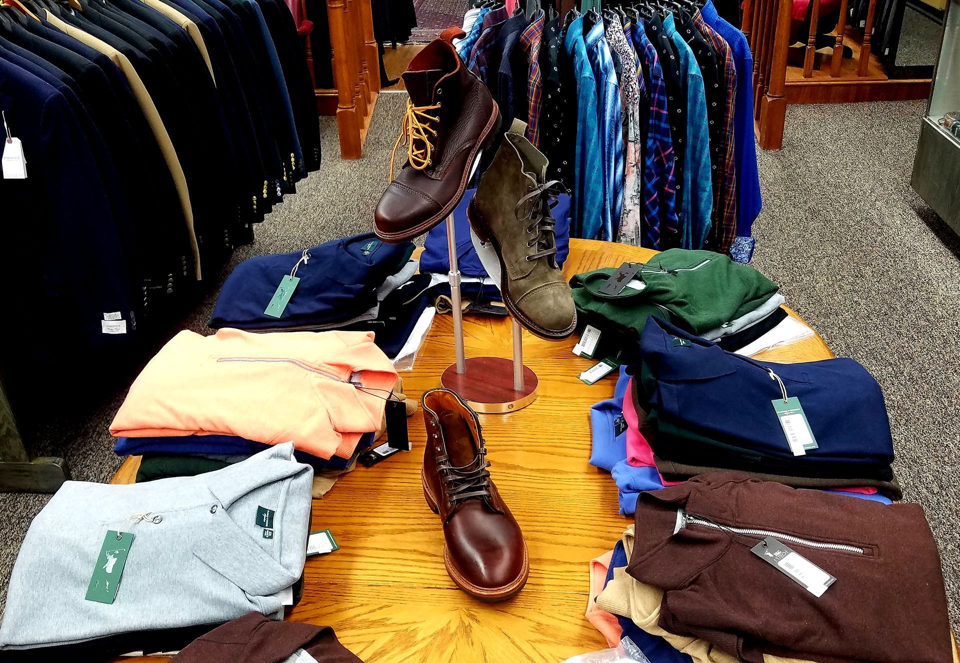 Men's clothing, shoes and accessories arranged on a store display