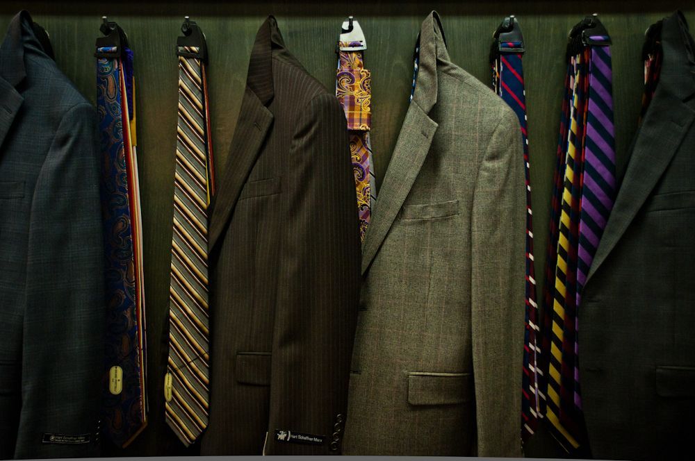 Men's suits and coordinating ties displayed at Blakley Mitchell