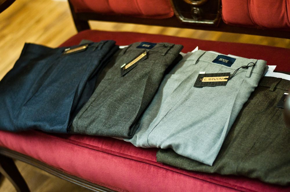 Men's dress pants and trousers displayed on a red bench