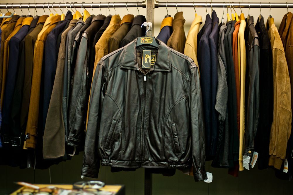 Men's leather jackets displayed on a clothing rack