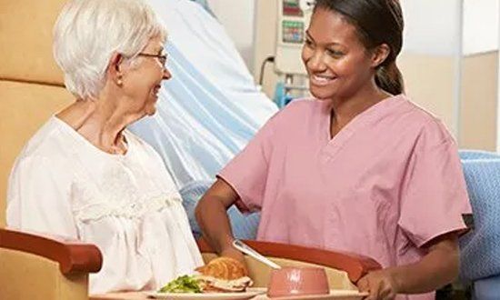Medical staff taking care of elderly woman