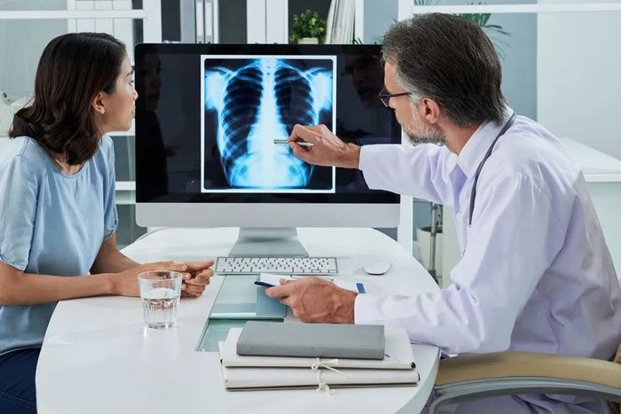 Doctor checking the x-ray of the woman