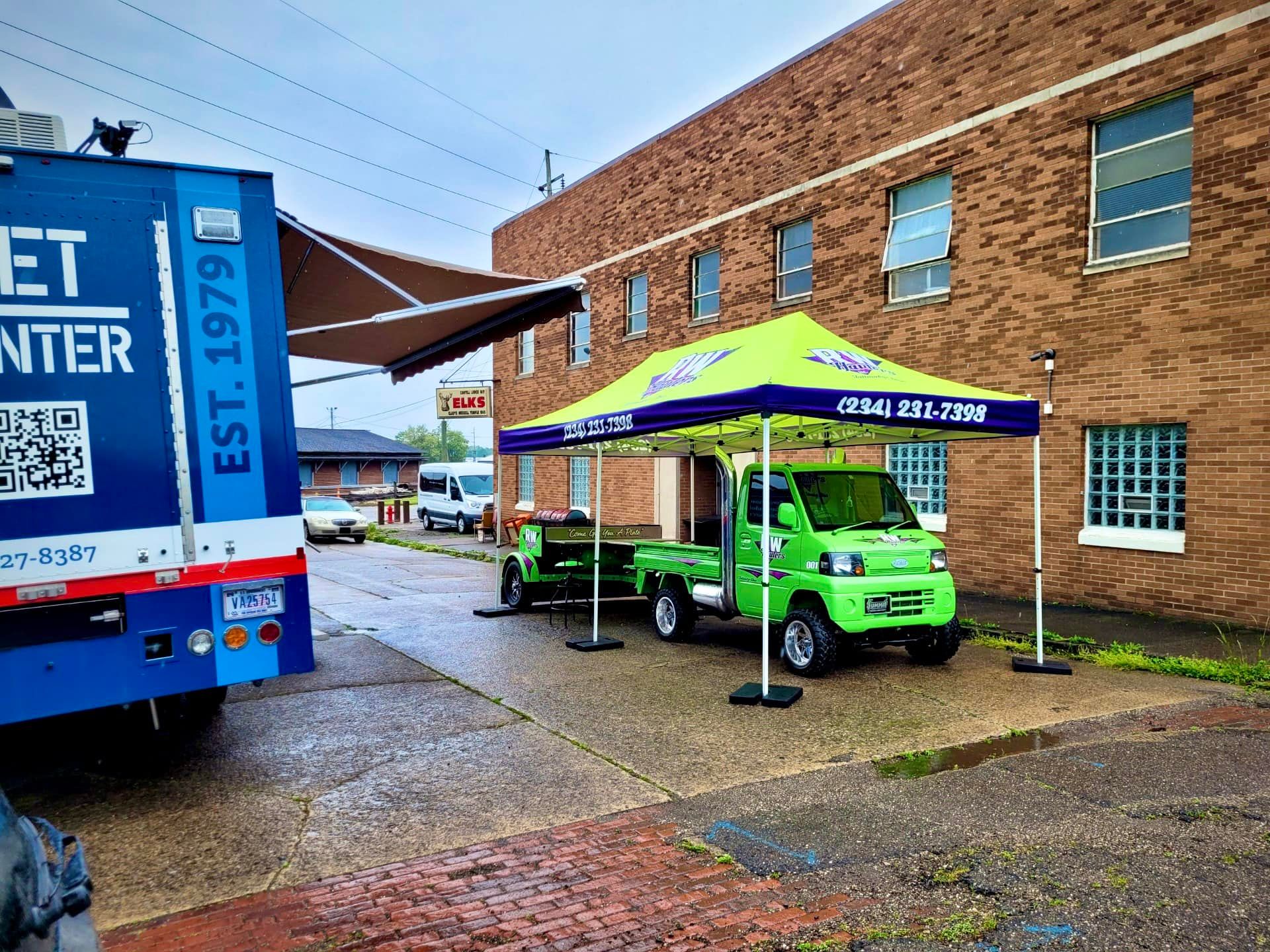 RW Hauler mini-truck at outdoor event underneath tent