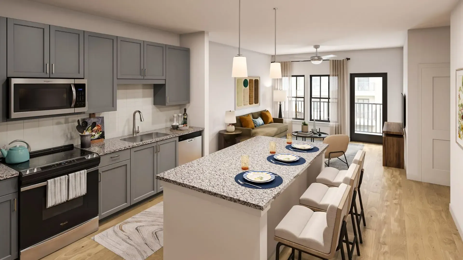 Modern kitchen with gray cabinets, island seating, and a long dining table in a bright open-plan room